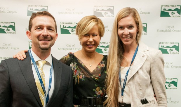 THE SIMPSONS: (L-R) City of Springfield, OR Communications Director Neil Laudati, Cast member Yeardley Smith and City of Springfield, OR Senior Analyst Courtney Griesel celebrate THE SIMPSONS 25th ANNIVERSARY with the unveiling of the Simpsons mural during a block party dedication ceremony on their downtown walk of murals on Monday, Aug. 25th. THE SIMPSONS ª and © 2014 TCFFC ALL RIGHTS RESERVED.