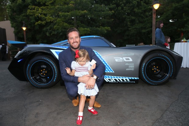 Armie Hammer (back) and Harper Hammer pose at the after party for the World Premiere of Disney/Pixar's "Cars 3" at Cars Land at Disney California Adventure. [Photo: Jesse Grant/Getty Images for Disney]