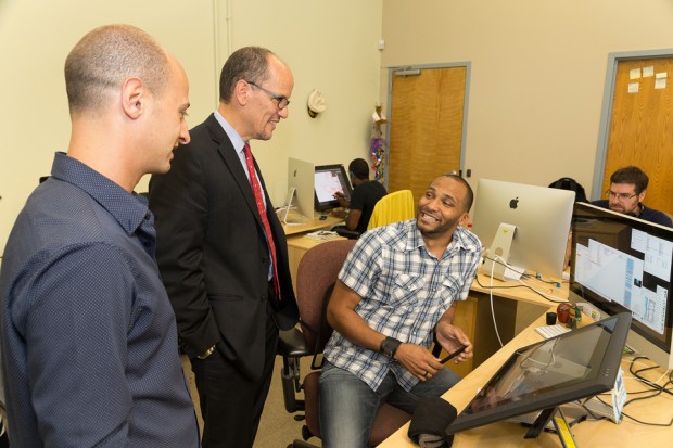 Animation Director Aaron Hawkins, left, Sec. of Labor Tom Perez and background artist Siddeeq Saafir. Hawkins lead Sec. Perez on a tour of the Atlanta studio to showcase all the staff there, including himself and Saafir, who received job training through the federal On the Job Training program that aims to provide training for workers in the U.S. so jobs can stay here rather than be shipped overseas.